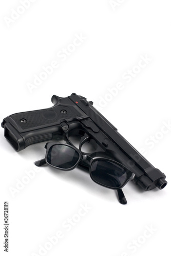 semi automatic handgun and sunglasses © Constantin