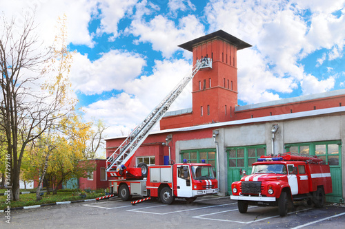 fire station, two red fire truck with long ladder photo