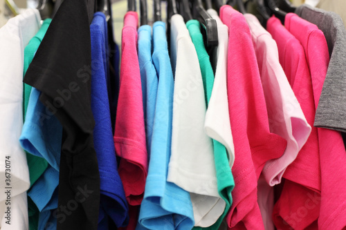 Variety of multicolored casual clothes in shop