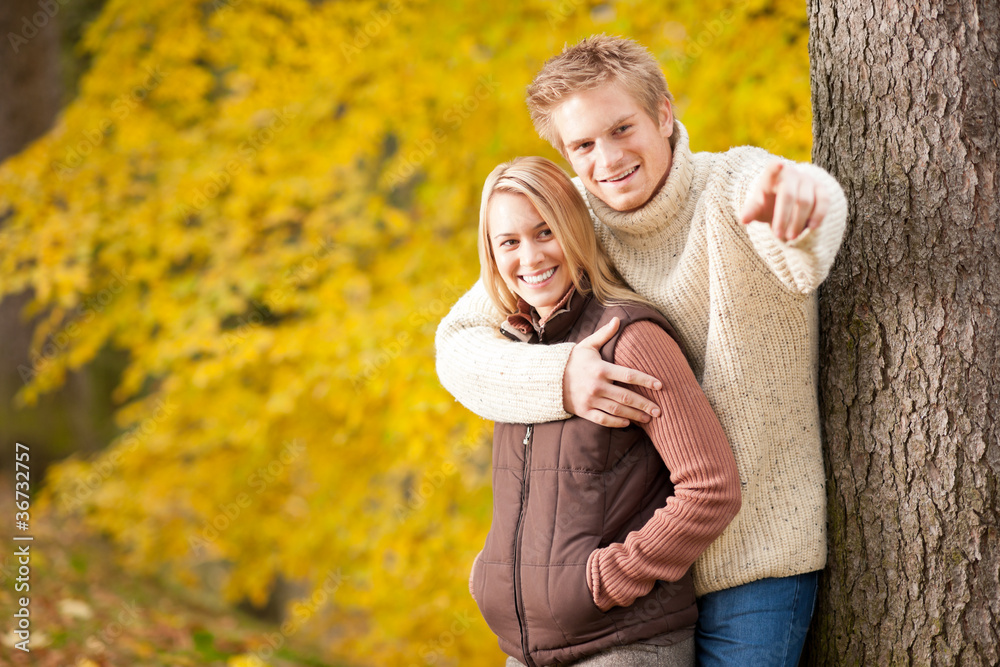 Fototapeta premium Autumn romantic couple smiling together in park