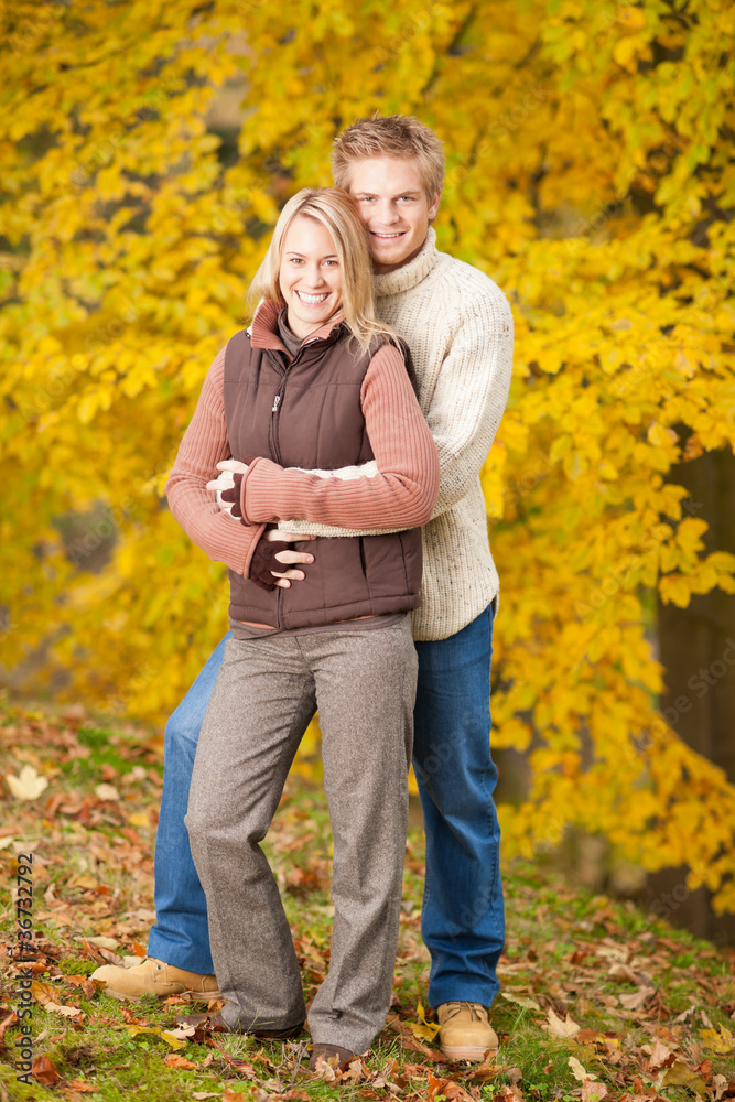 Autumn love couple hugging happy in park Autumn love couple hugging happy in park