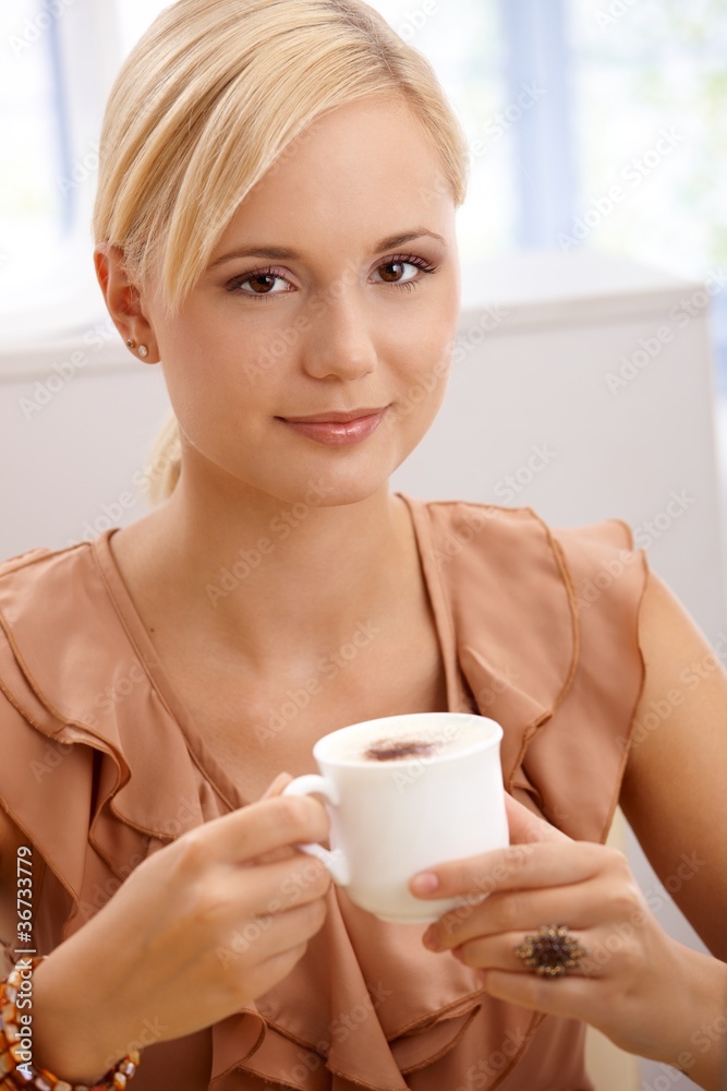 Smiling blonde drinking cappuccino Smiling blonde drinking cappuccino