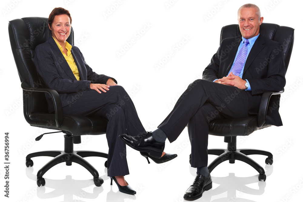 Mature business people sat in chairs