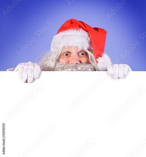 Santa Claus holding a blank sign © milkovasa