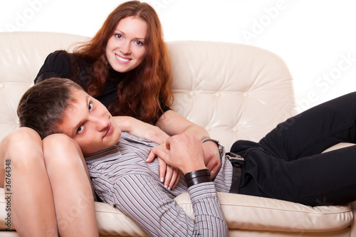 young man lies in the lap of woman