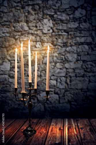 Candleholder in front of old Wall
