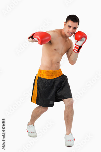 Young boxer performing a right hook © WavebreakmediaMicro