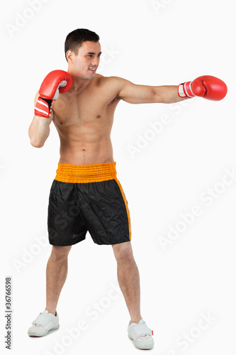 Side view of boxer hitting straight © WavebreakmediaMicro