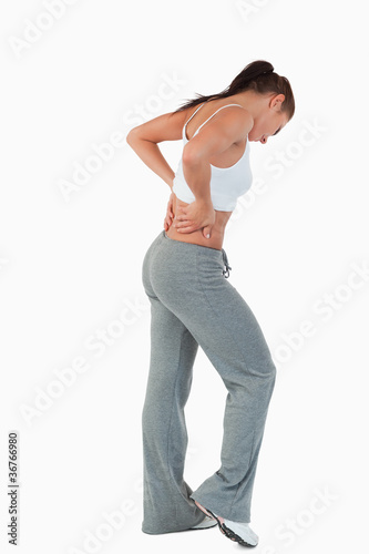 Side view of young woman with hands on her hip