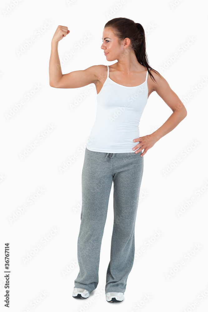 Young woman showing her biceps