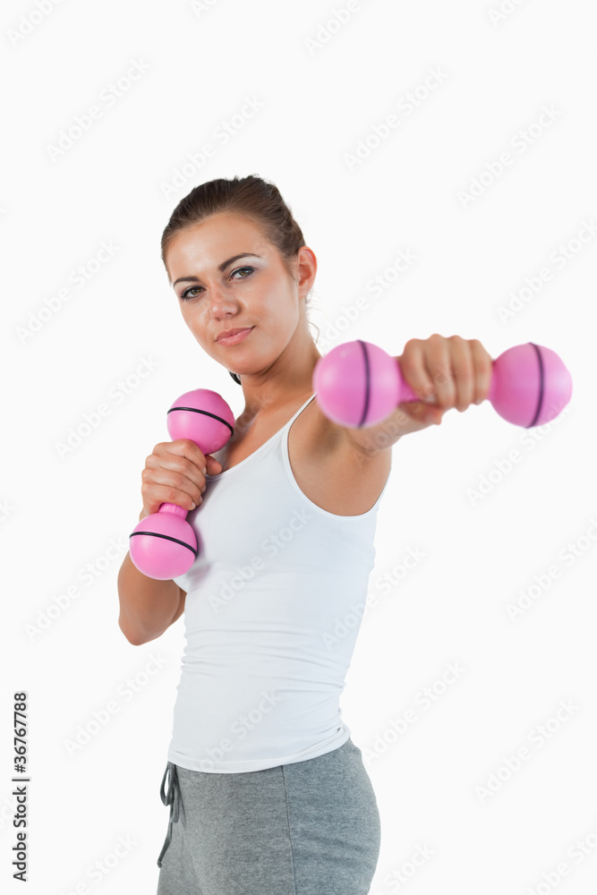 Portrait of a beautiful woman working out with dumbbells Portrait of a beautiful woman working out with dumbbells