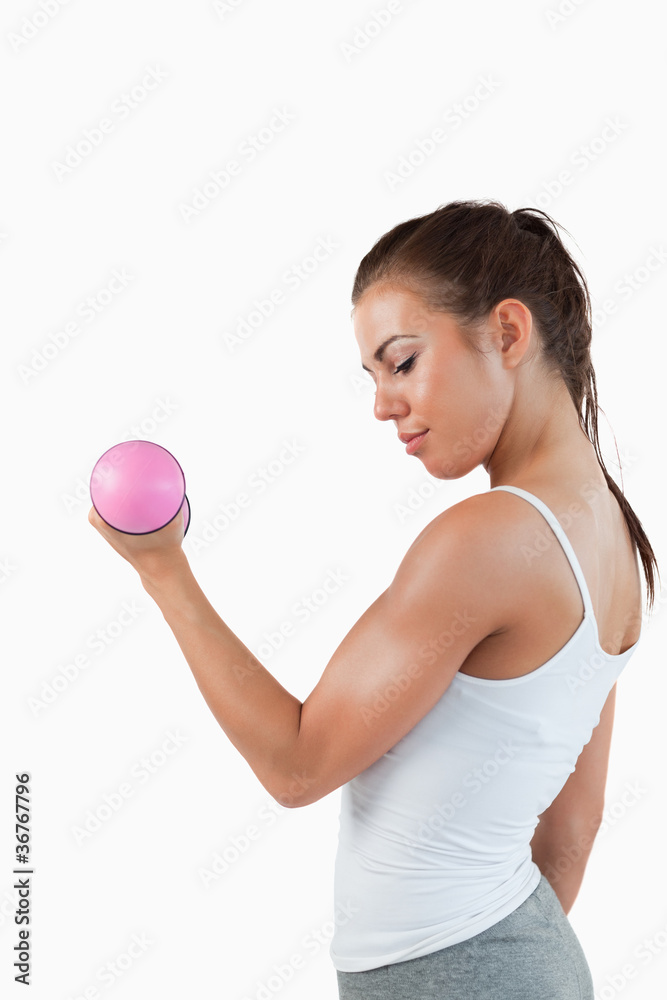 Portrait of a muscular woman working out with dumbbells Portrait of a muscular woman working out with dumbbells