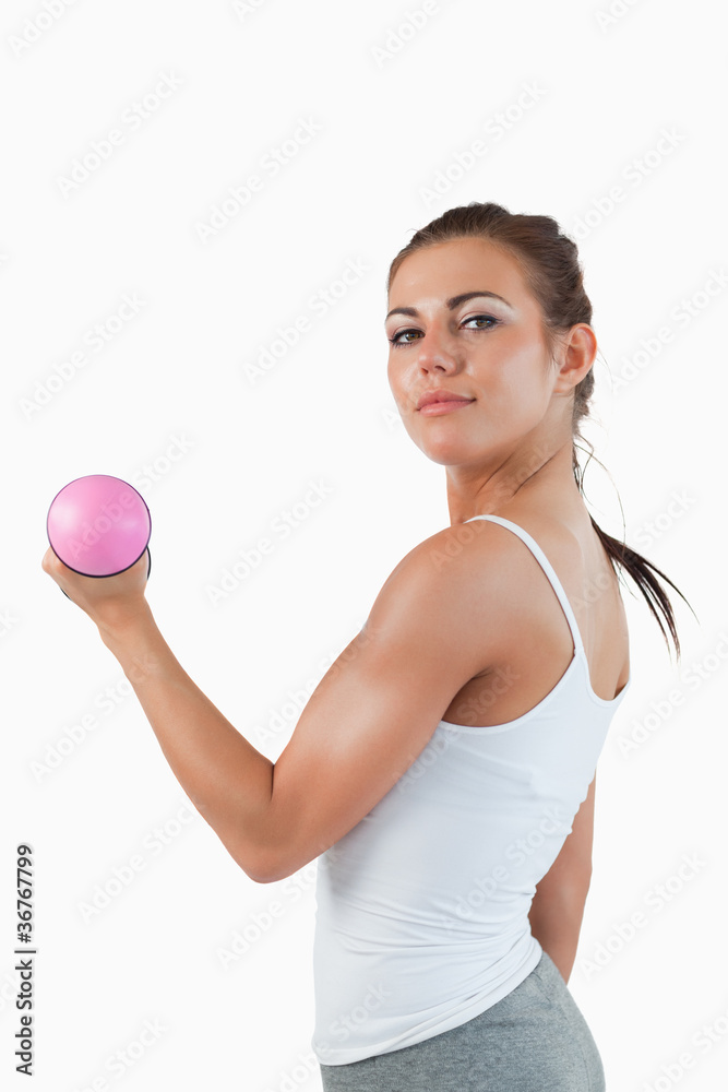 Portrait of a brunette woman working out with dumbbells Portrait of a brunette woman working out with dumbbells