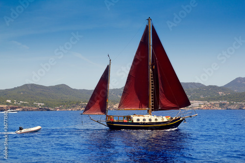 Ibiza Red sails sailboat in Sa Talaia coast