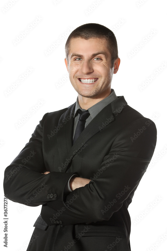 Young businessman standing with folded hands Young businessman standing with folded hands