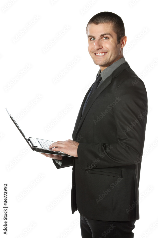 Young businessman working on laptop over white Young businessman working on laptop over white