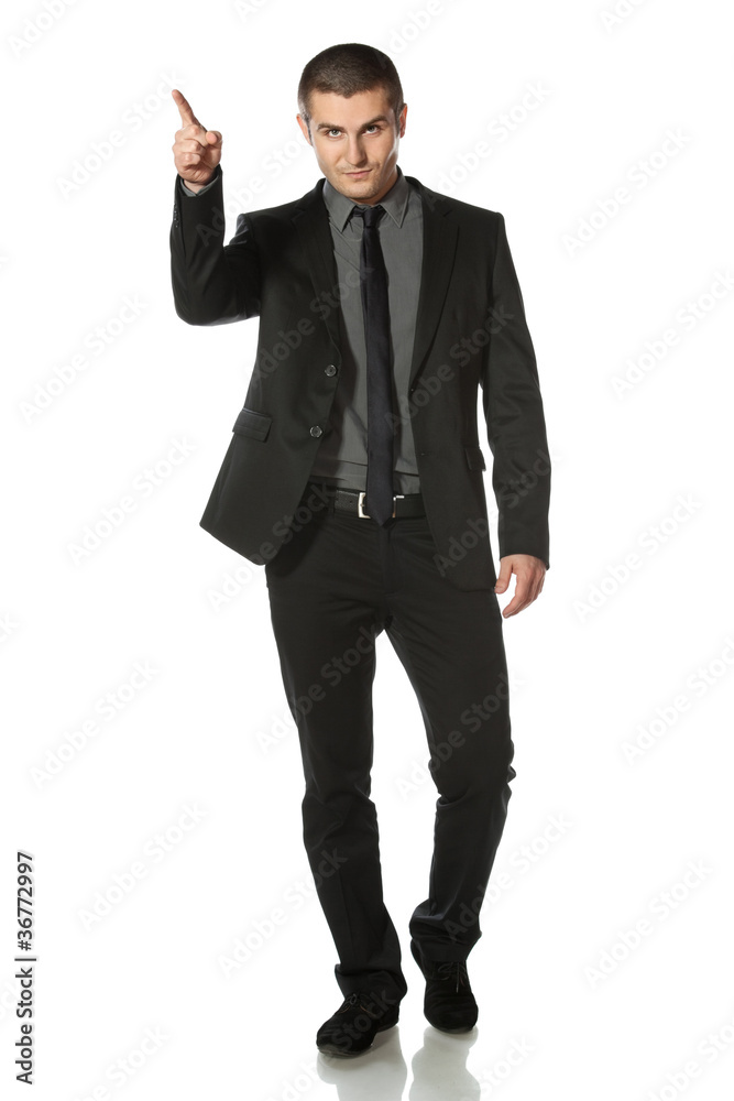 Full length of young business man in suit pointing Full length of young business man in suit pointing