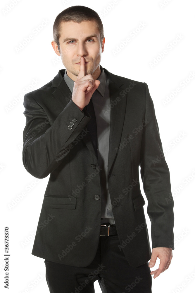 Business man with finger on lips asking for silence Business man with finger on lips asking for silence
