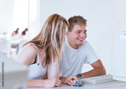 two college students having fun studying together
