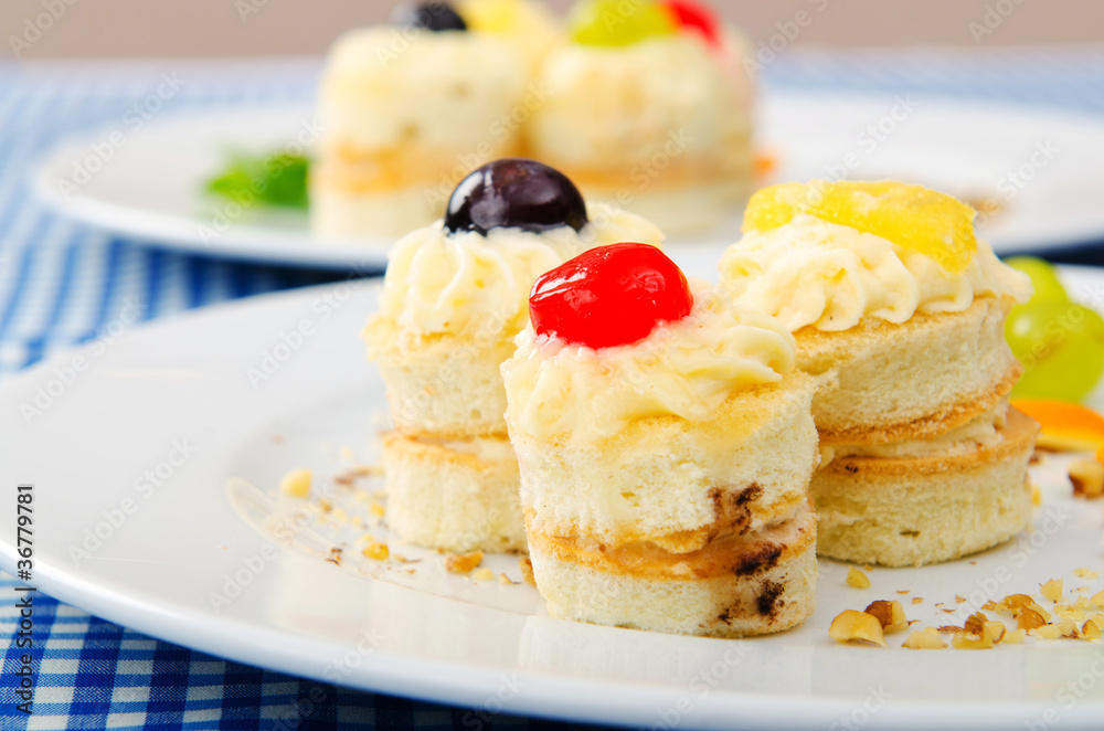 Plate full of tasty mini cakes Plate full of tasty mini cakes