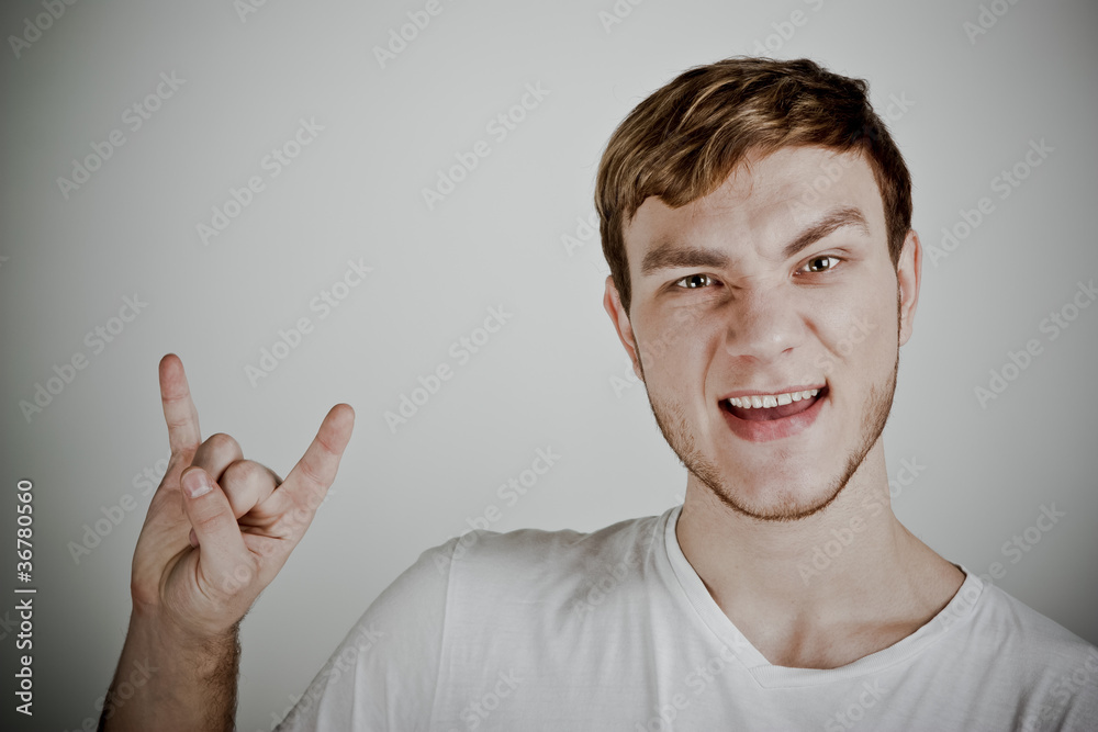 Young man with characteristic heavy metal hand gesture Young man with characteristic heavy metal hand gesture