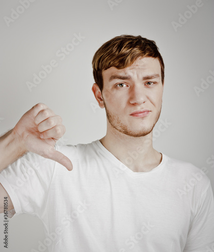 young man shows thumb down