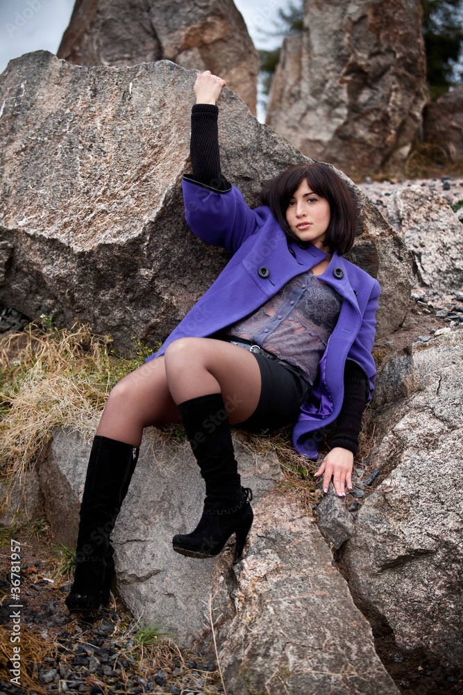 Young caucasian girl sitting on cliff Young caucasian girl sitting on cliff
