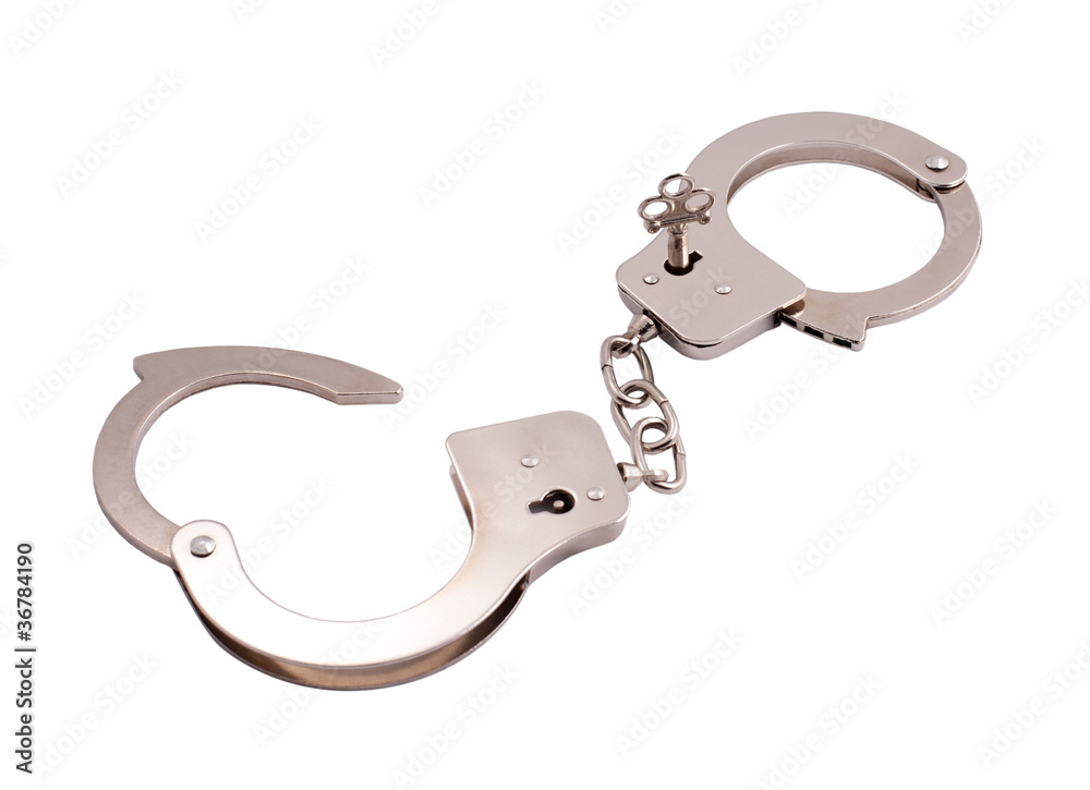 opened handcuffs with a key isolated on white opened handcuffs with a key isolated on white