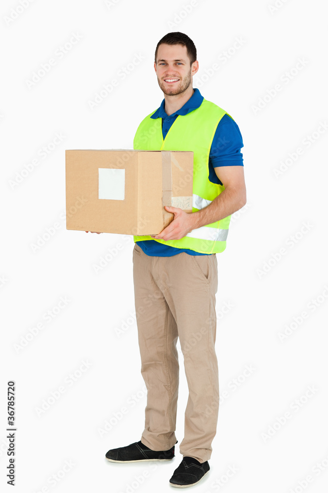 Smiling young delivery man holding a parcel Smiling young delivery man holding a parcel
