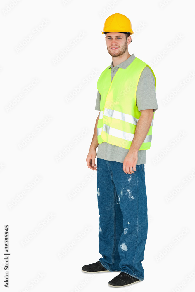 Side view of smiling young construction worker Side view of smiling young construction worker
