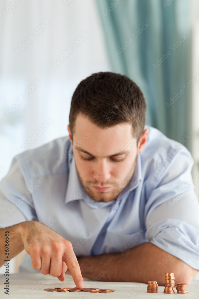Desperate businessman counting change Desperate businessman counting change