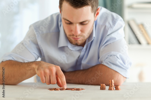 Businessman counting his small coins