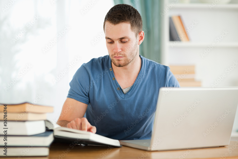 Student using his laptop for his homework Student using his laptop for his homework