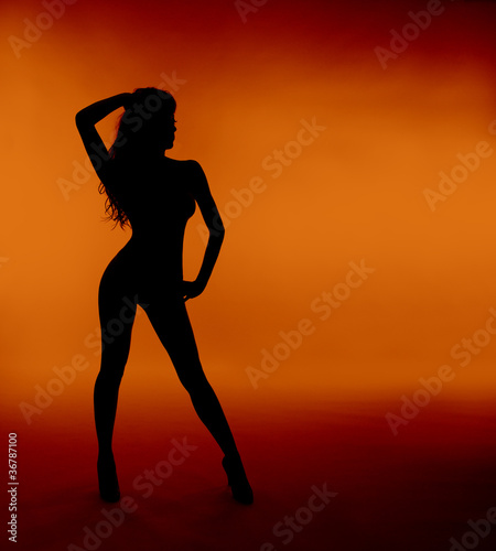 woman sexy silhouette over orange background