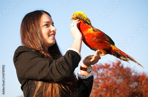 The happy teen with a pheasant on hand