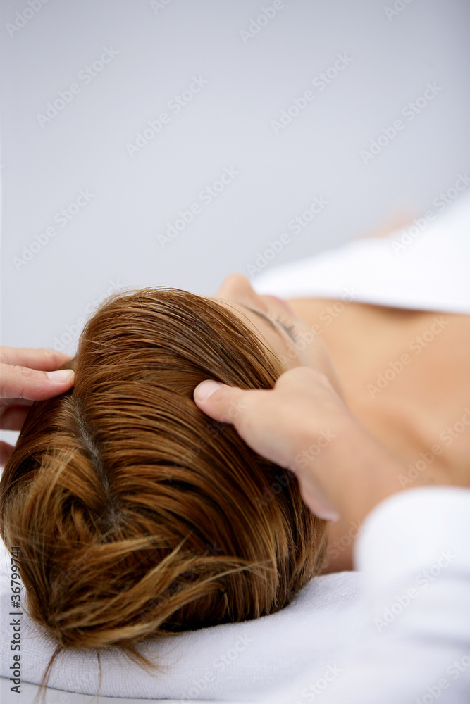 Fototapeta premium Woman being treated to soothing head massage