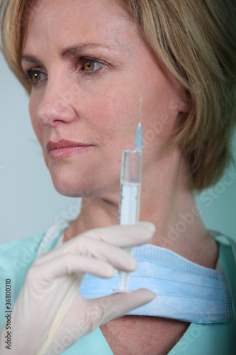 Female nurse holding syringe