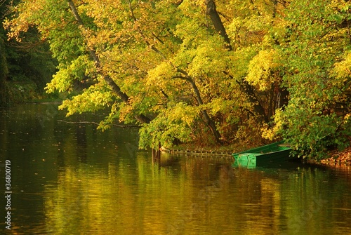 Small green boat on the Beautiful lake