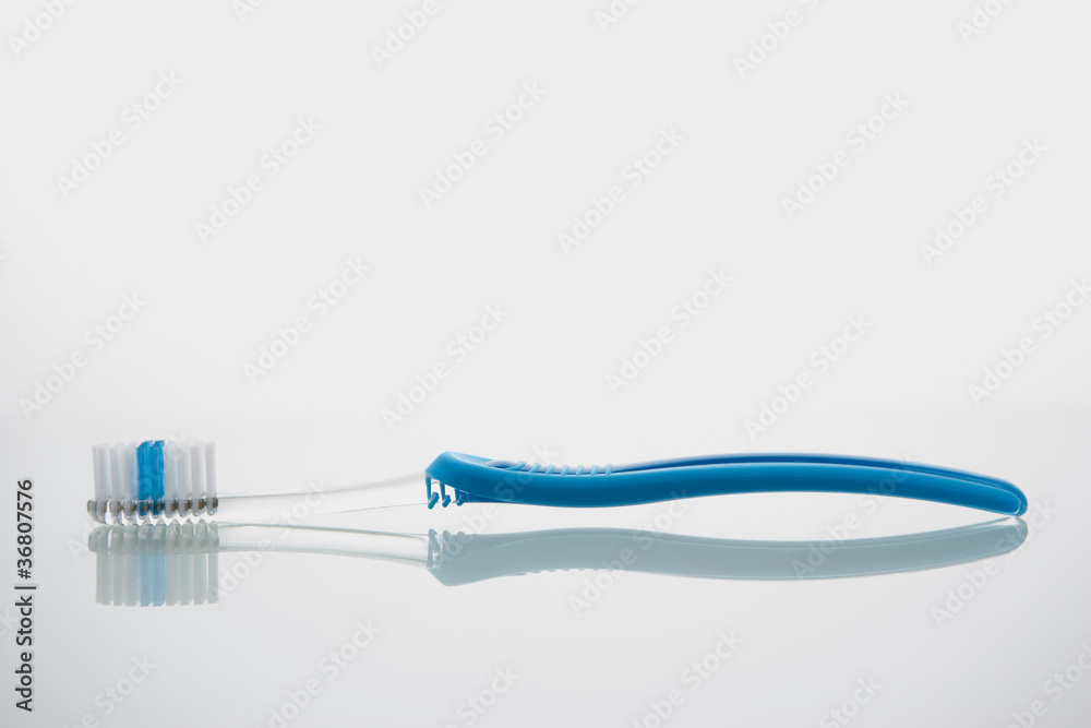 Toothbrush lying on glass shelf Toothbrush lying on glass shelf