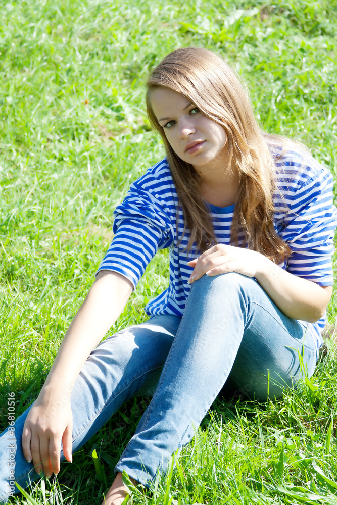 beautiful girl in the shirt on the grass