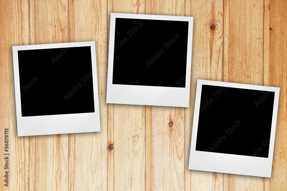 instant photo frame on wooden background. instant photo frame on wooden background.