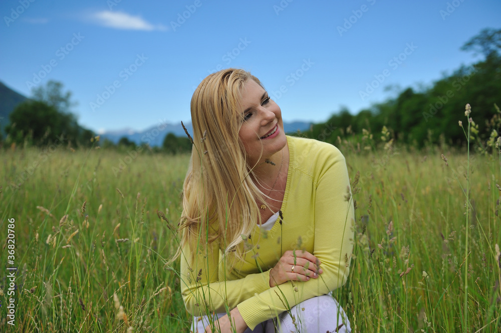 Pretty healthy summer woman on green field in Alps. Switzerland Pretty healthy summer woman on green field in Alps. Switzerland