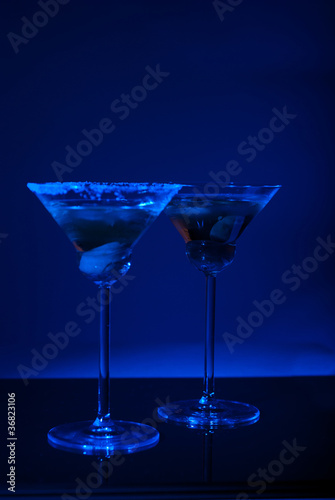 Two martini glasses with blue light