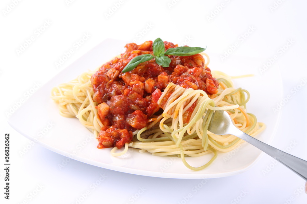Spaghetti bolognese on a plate being eaten with a fork Spaghetti bolognese on a plate being eaten with a fork