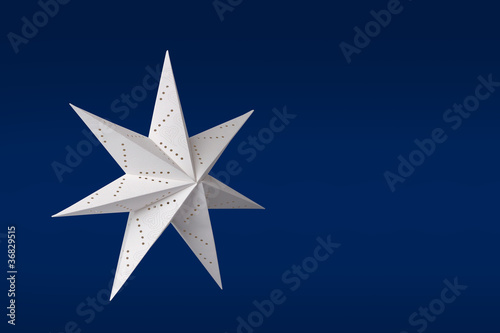 White paper star on blue