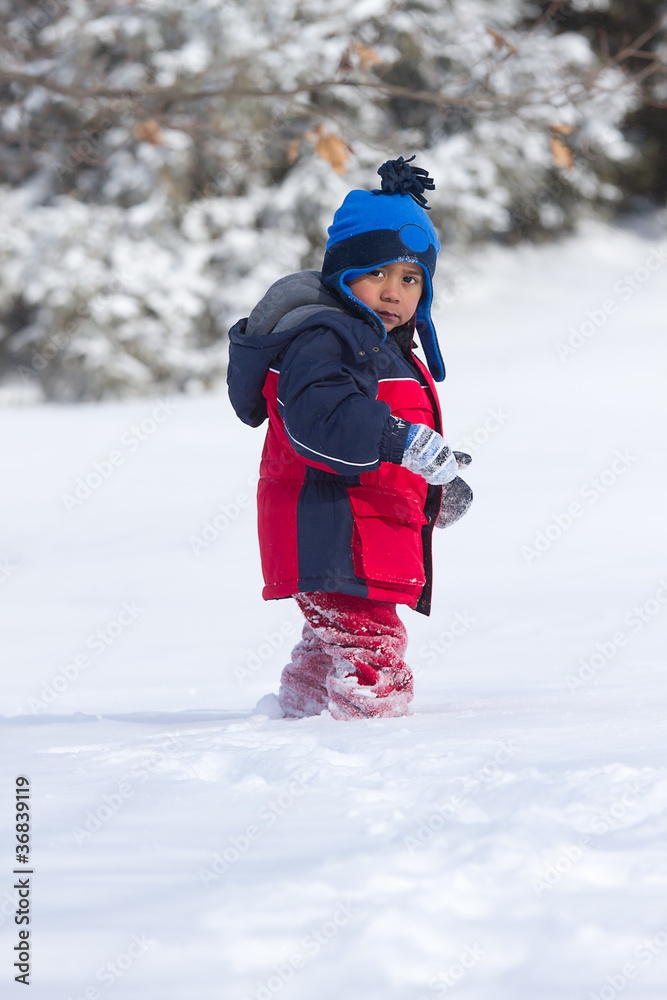 Child walking on snow almost knee deep