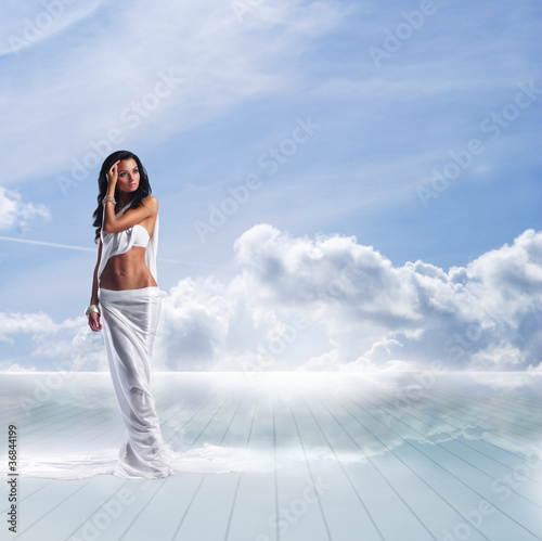 A young brunette woman in a beautiful white dress