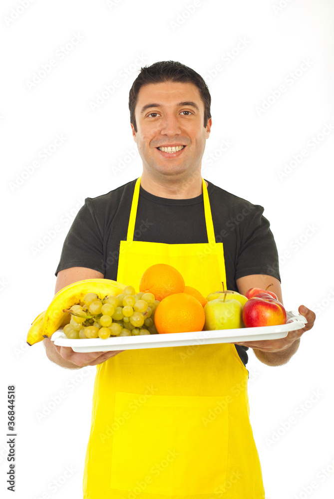 Happy fruiterer offering fresh fruits Happy fruiterer offering fresh fruits