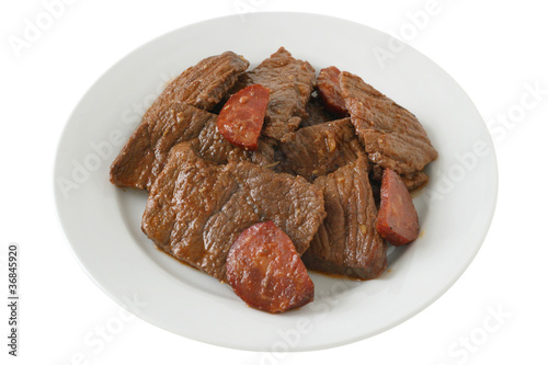 beef with sausages on plate