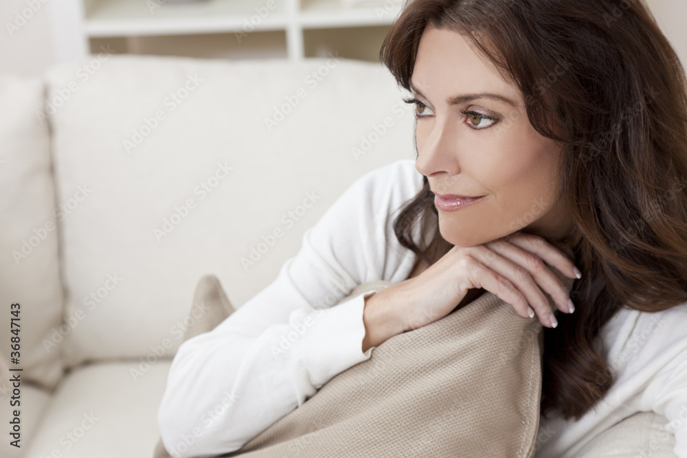 Brunette Woman Sitting Thinking At Home on Sofa Brunette Woman Sitting Thinking At Home on Sofa
